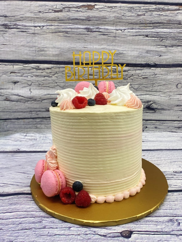 Elegant Birthday Cake with Berries and Macarons